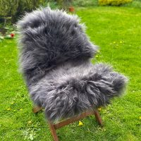 Dark grey icelandic sheepskin rug on a chair