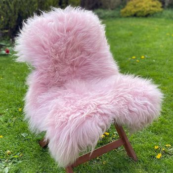 Pink icelandic sheepskin rug on a chair