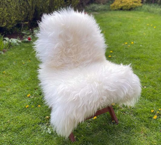 Natural white icelandic sheepskin rug on a chair