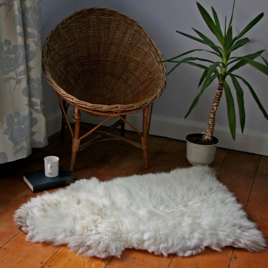 Natural white Glencroft British sheepskin rug on the floor