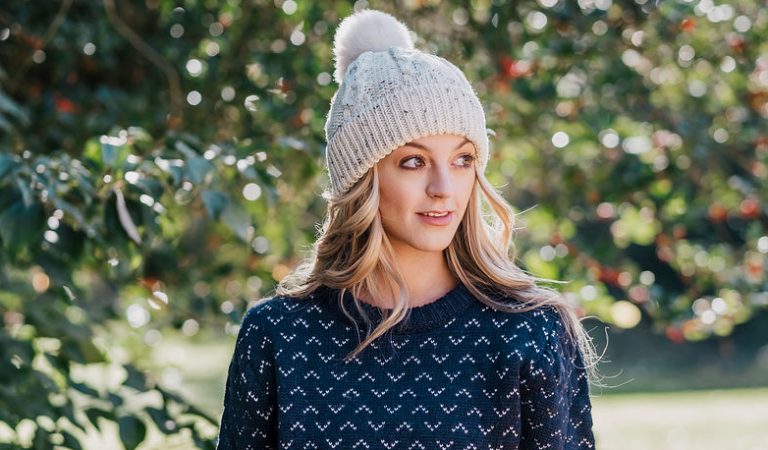 female wearing saxon jumper and sheepskin bobble hat