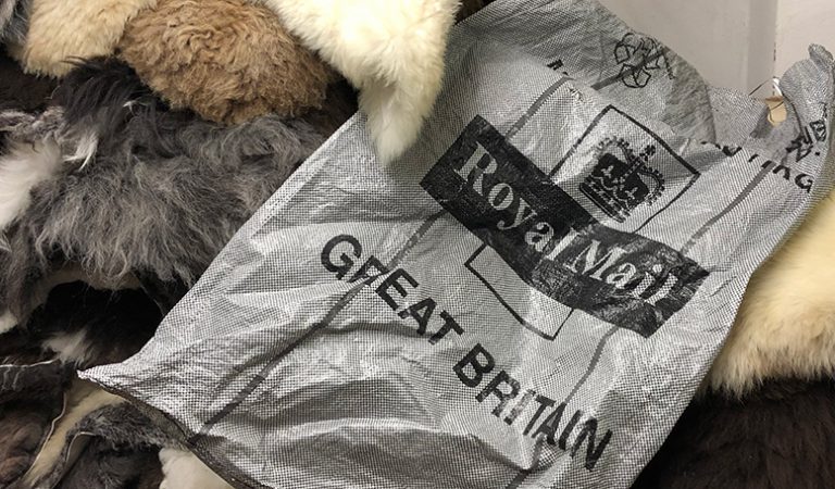Royal Mail posting sack on some sheepskin rugs