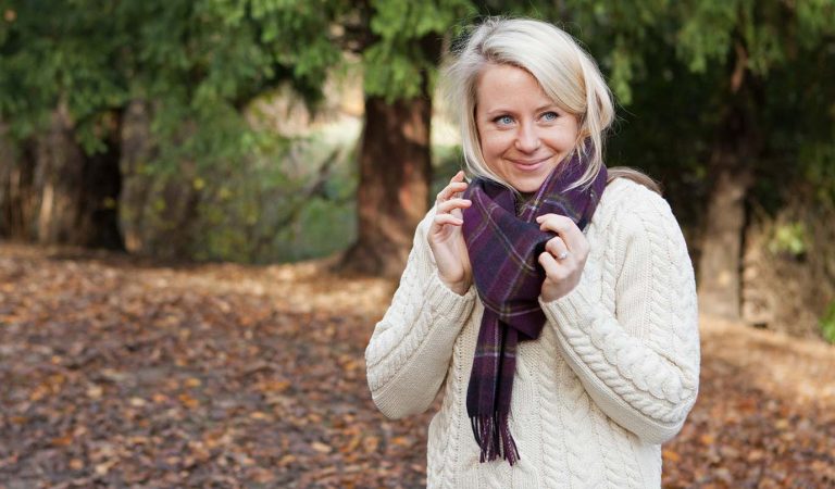 Woman in cashmere scarf and aran jumper