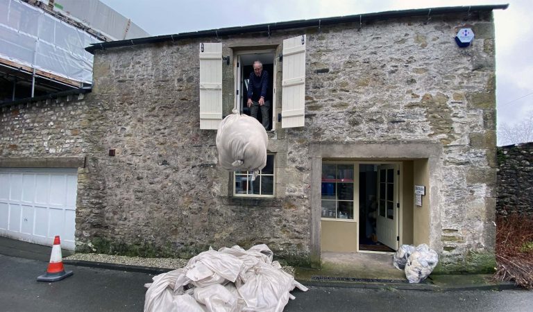 Bales of wool being dropped from the stable hay barn